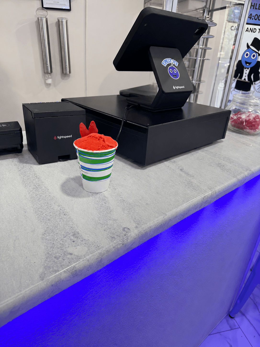 A cup of bright red strawberry water ice on the Really Ice counter